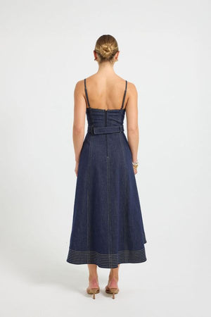 Indie Flared Midi in Indigo Denim by Pasduchas, a stretch denim midi with V-neckline, flared hem, contrast topstitching, and removable belt for tailored finish.
