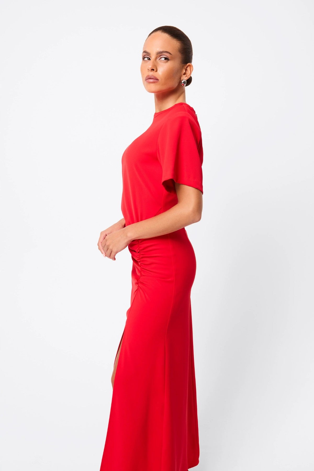 Infusion Maxi Dress in Red by Mossman, a refined crew-neck maxi with asymmetric ruching and fluid drape for effortless day-to-evening elegance.