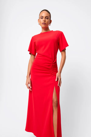 Infusion Maxi Dress in Red by Mossman, a refined crew-neck maxi with asymmetric ruching and fluid drape for effortless day-to-evening elegance.