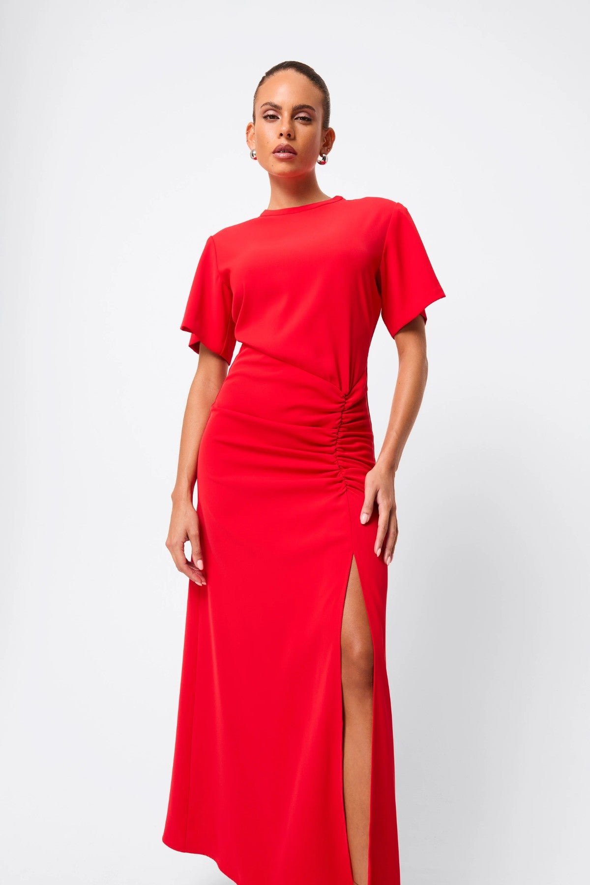 Infusion Maxi Dress in Red by Mossman, a refined crew-neck maxi with asymmetric ruching and fluid drape for effortless day-to-evening elegance.