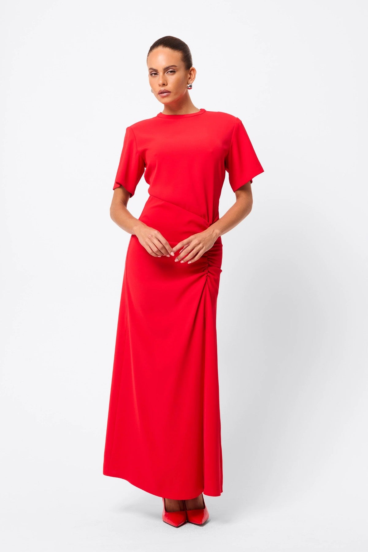 Infusion Maxi Dress in Red by Mossman, a refined crew-neck maxi with asymmetric ruching and fluid drape for effortless day-to-evening elegance.