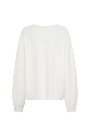 Jaz Oversized V Neck Knit Sweater in White with a deep V neckline and relaxed slouchy fit, creating a soft draped silhouette with a clean, oversized finish.
