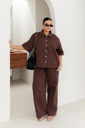 Jaz Hand Denim Shirt Chocolate by Sneaky Link – a button-up denim shirt with collar and short sleeves. Perfect for elevated styling.