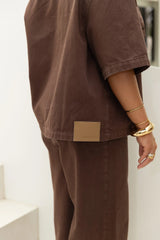 Jaz Hand Denim Shirt Chocolate by Sneaky Link – a button-up denim shirt with collar and short sleeves. Perfect for elevated styling.