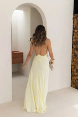 Jaz Hand V-Neck Maxi Dress in Butter by Sneaky Link, a flowing one-shoulder silhouette in soft yellow. Perfect for summer events or weddings.
