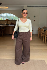 Jaz Mid Rise Relaxed Suit Pant in Chocolate with a mid rise waist and straight leg fit, creating a relaxed, fluid silhouette with a soft, tailored finish.