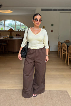 Jaz Mid Rise Relaxed Suit Pant in Chocolate with a mid rise waist and straight leg fit, creating a relaxed, fluid silhouette with a soft, tailored finish.