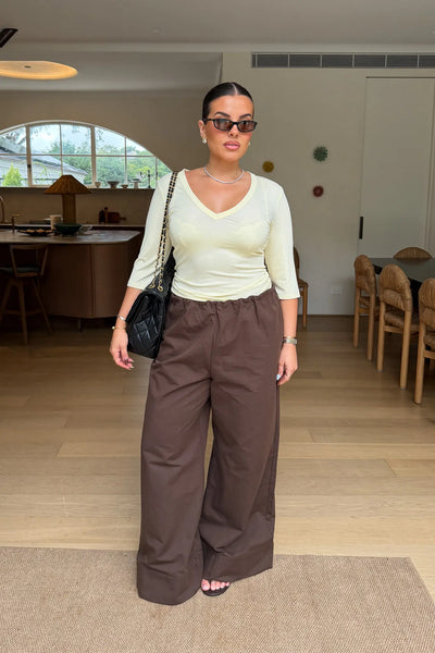 Jaz Mid Rise Relaxed Suit Pant in Chocolate with a mid rise waist and straight leg fit, creating a relaxed, fluid silhouette with a soft, tailored finish.