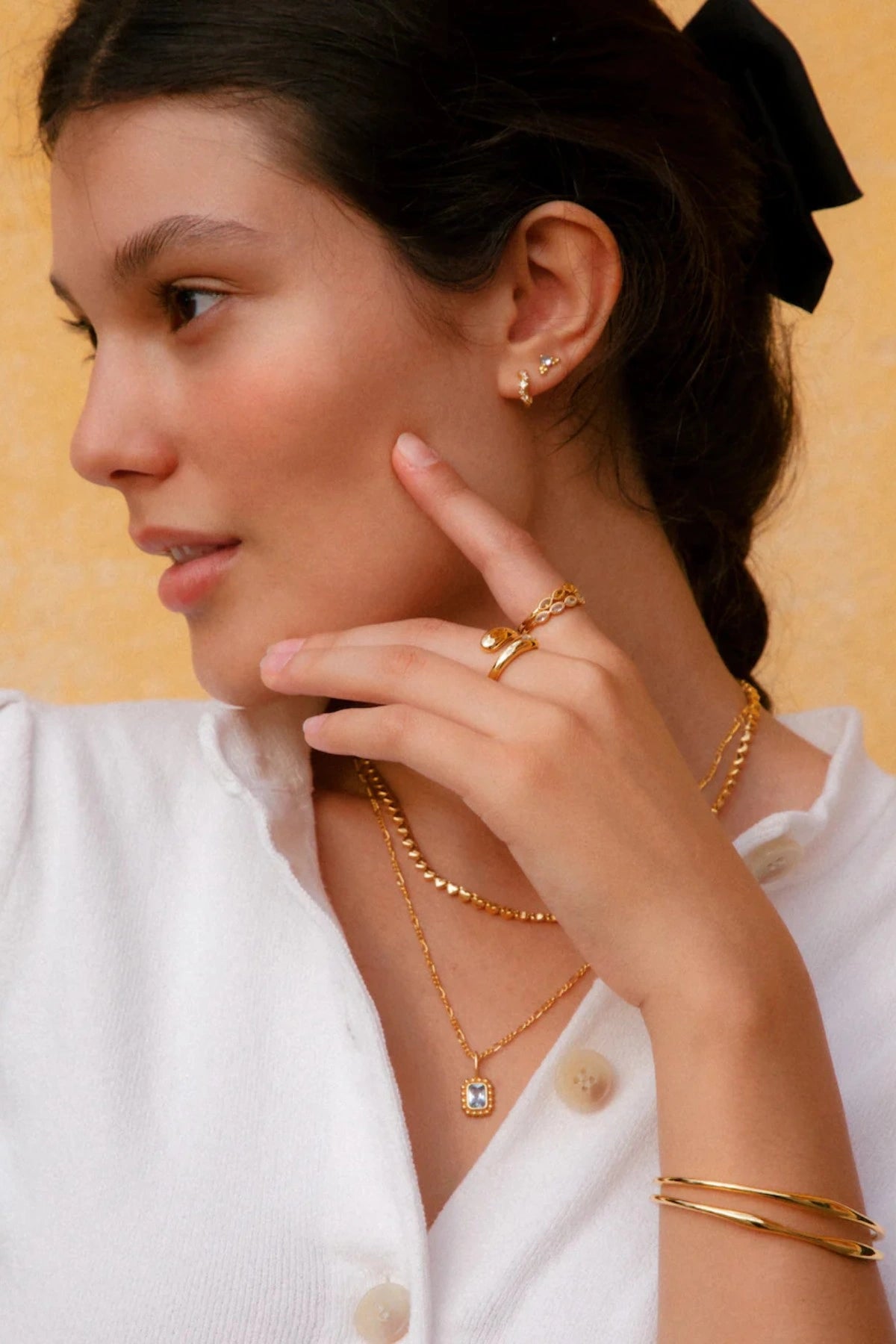 Jemima Huggies by Avant Studio, dainty gold hoops with pastel CZ gems. Perfect for subtle ear stacks and everyday styling.