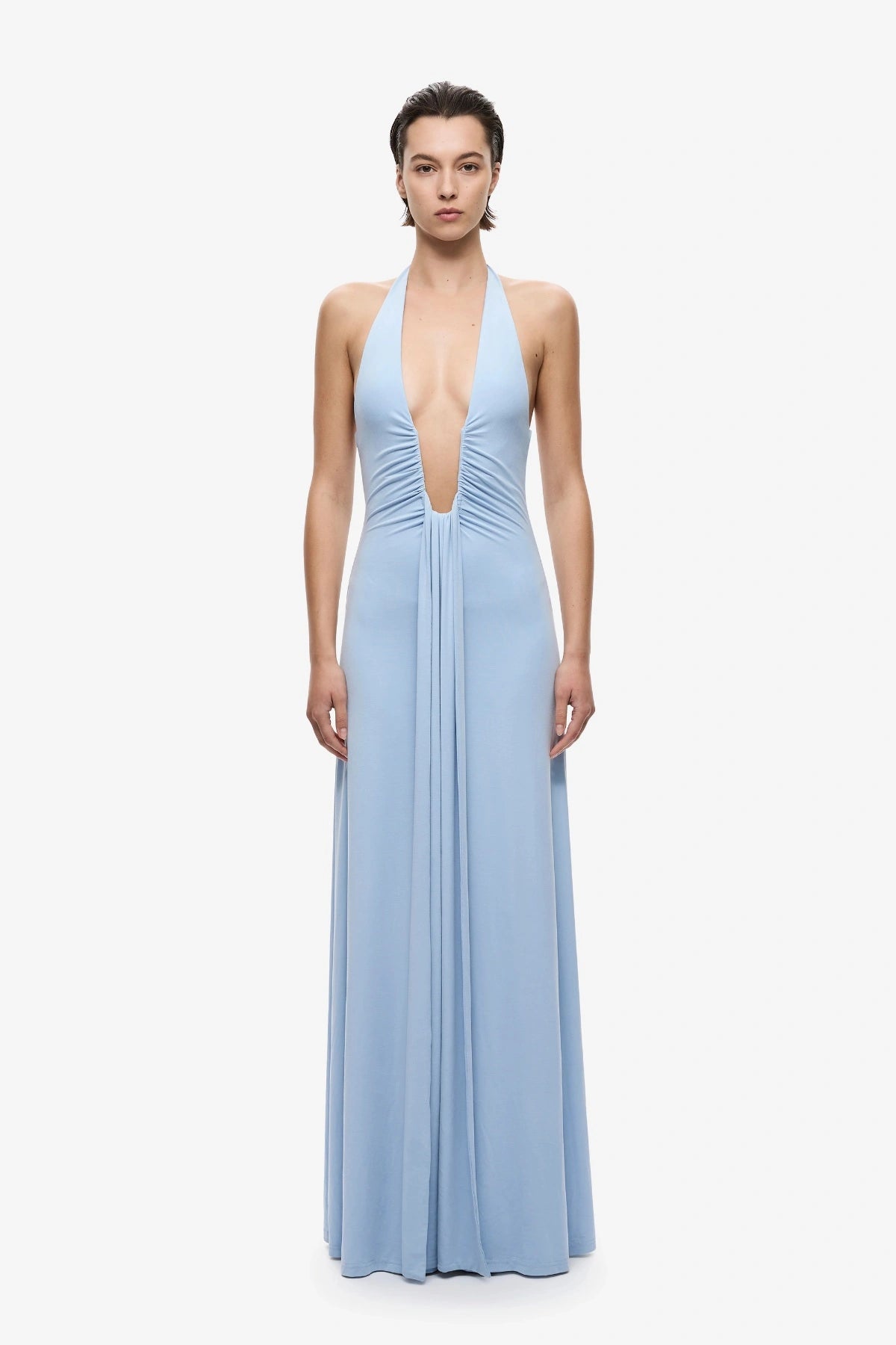 Jennifer Cupro Dress Cornflower Blue by Misha, a plunging halter maxi with gathered waist and waterfall sash for fluid, elegant movement.
