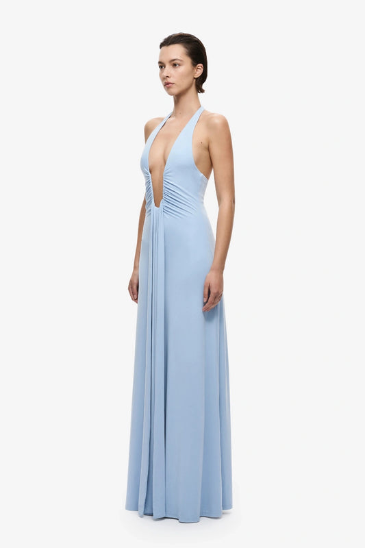 Jennifer Cupro Dress Cornflower Blue by Misha, a plunging halter maxi with gathered waist and waterfall sash for fluid, elegant movement.
