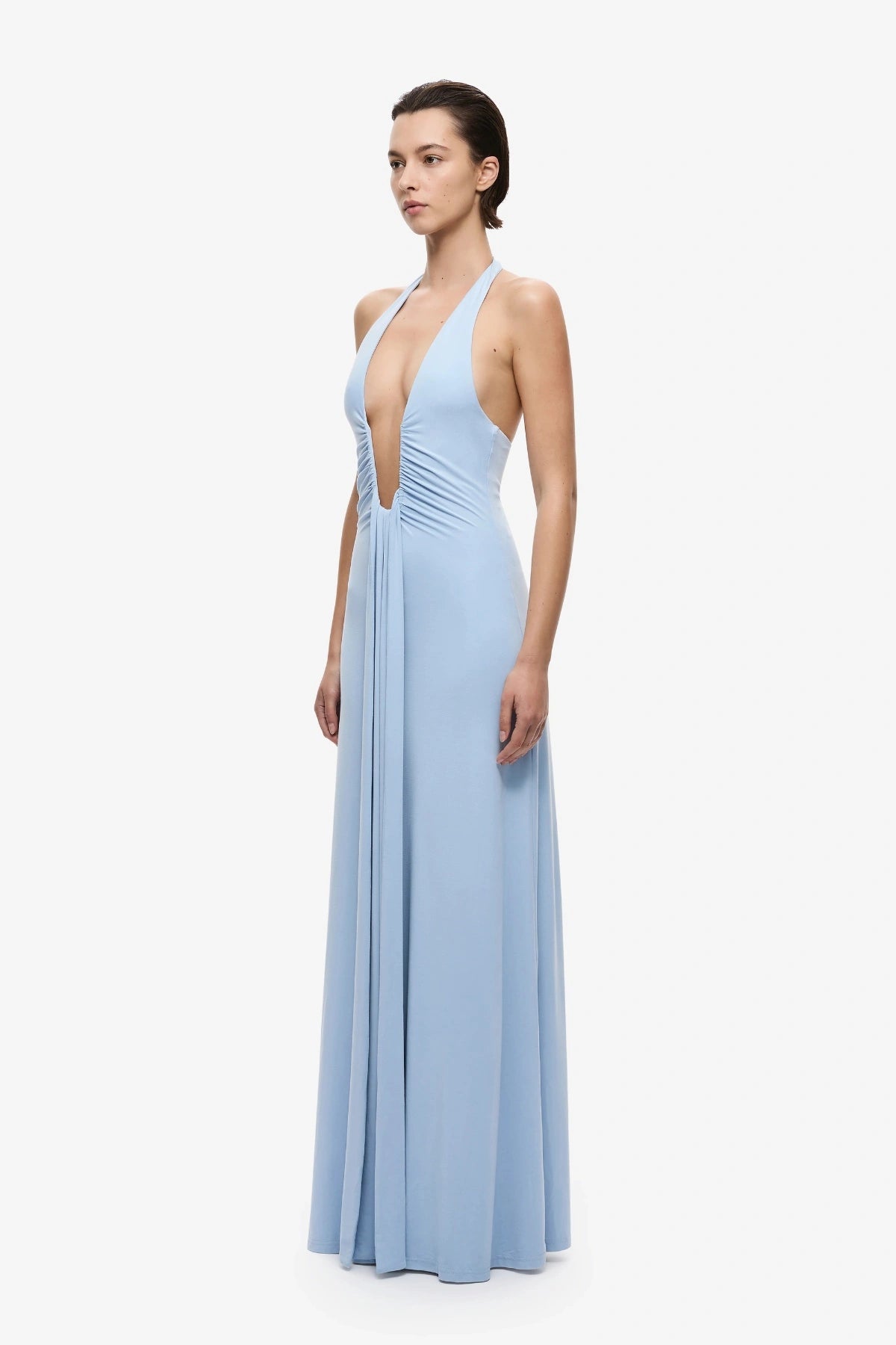 Jennifer Cupro Dress Cornflower Blue by Misha, a plunging halter maxi with gathered waist and waterfall sash for fluid, elegant movement.
