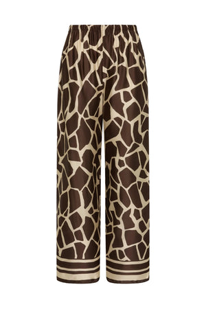 Jensen Pant in Ombra by Faithfull the Brand, a mid-rise satin pant with elasticated waist, wide straight leg, and animal print finish.