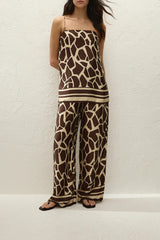 Jensen Pant in Ombra by Faithfull the Brand, a mid-rise satin pant with elasticated waist, wide straight leg, and animal print finish.