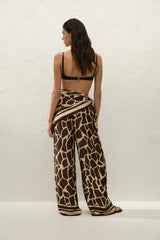 Jensen Pant in Ombra by Faithfull the Brand, a mid-rise satin pant with elasticated waist, wide straight leg, and animal print finish.