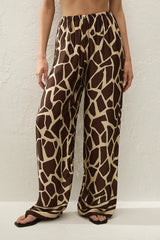 Jensen Pant in Ombra by Faithfull the Brand, a mid-rise satin pant with elasticated waist, wide straight leg, and animal print finish.