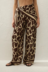 Jensen Pant in Ombra by Faithfull the Brand, a mid-rise satin pant with elasticated waist, wide straight leg, and animal print finish.