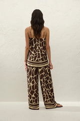 Jensen Pant in Ombra by Faithfull the Brand, a mid-rise satin pant with elasticated waist, wide straight leg, and animal print finish.
