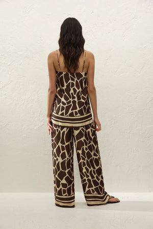 Jensen Pant in Ombra by Faithfull the Brand, a mid-rise satin pant with elasticated waist, wide straight leg, and animal print finish.