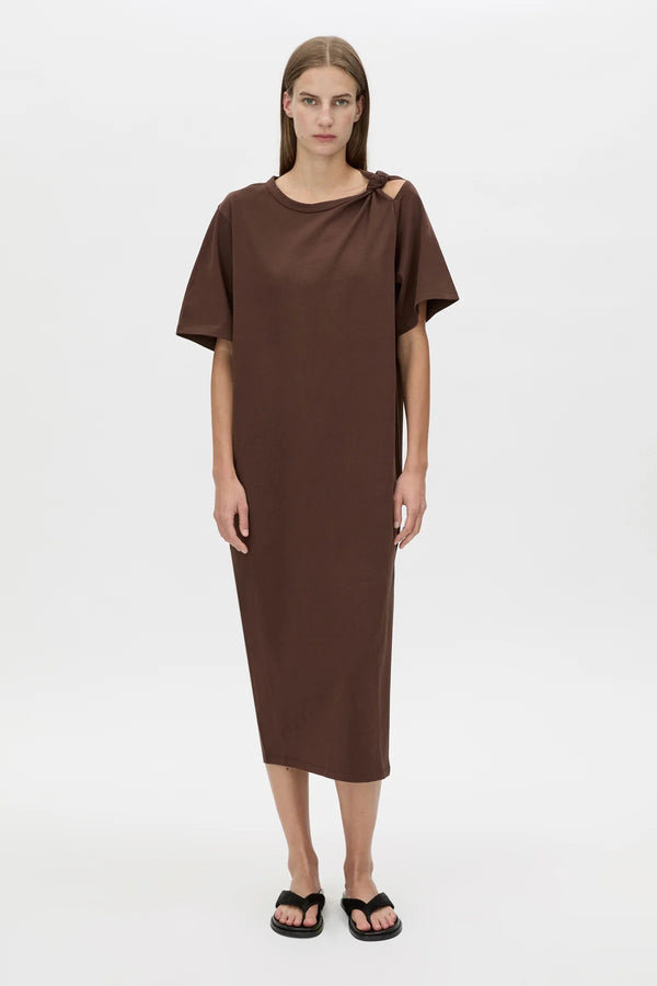 Juno Knot Tee Dress by Camilla and Marc — a chocolate cotton maxi with an asymmetric cut-out and draped knot detail for modern everyday wear.