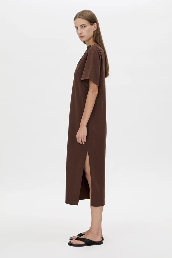 Juno Knot Tee Dress by Camilla and Marc — a chocolate cotton maxi with an asymmetric cut-out and draped knot detail for modern everyday wear.