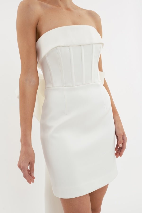 Lia Strapless Mini Dress Ivory by Rebecca Vallance – A corset mini with a bow-back and bonded crepe finish, perfect for modern bridal moments and elegant celebrations.