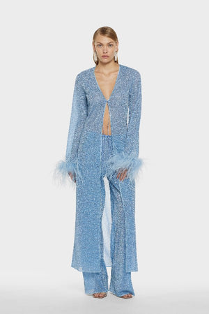 Lumière Pants Crystal by Oséree, elegant straight-leg pants in shimmering crystal blue metallic fabric. Lightweight with an elastic waistband, perfect for relaxed resort or evening wear.