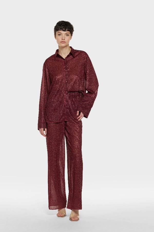 Lumière Pants Burgundy by Oséree, luxurious straight-fit pants in rich burgundy metallic fabric. Lightweight with an elastic waistband, perfect for day-to-night elegance.