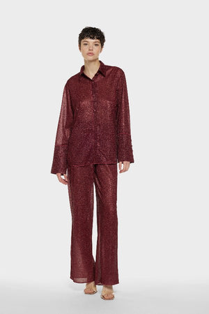 Lumière Pants Burgundy by Oséree, luxurious straight-fit pants in rich burgundy metallic fabric. Lightweight with an elastic waistband, perfect for day-to-night elegance.