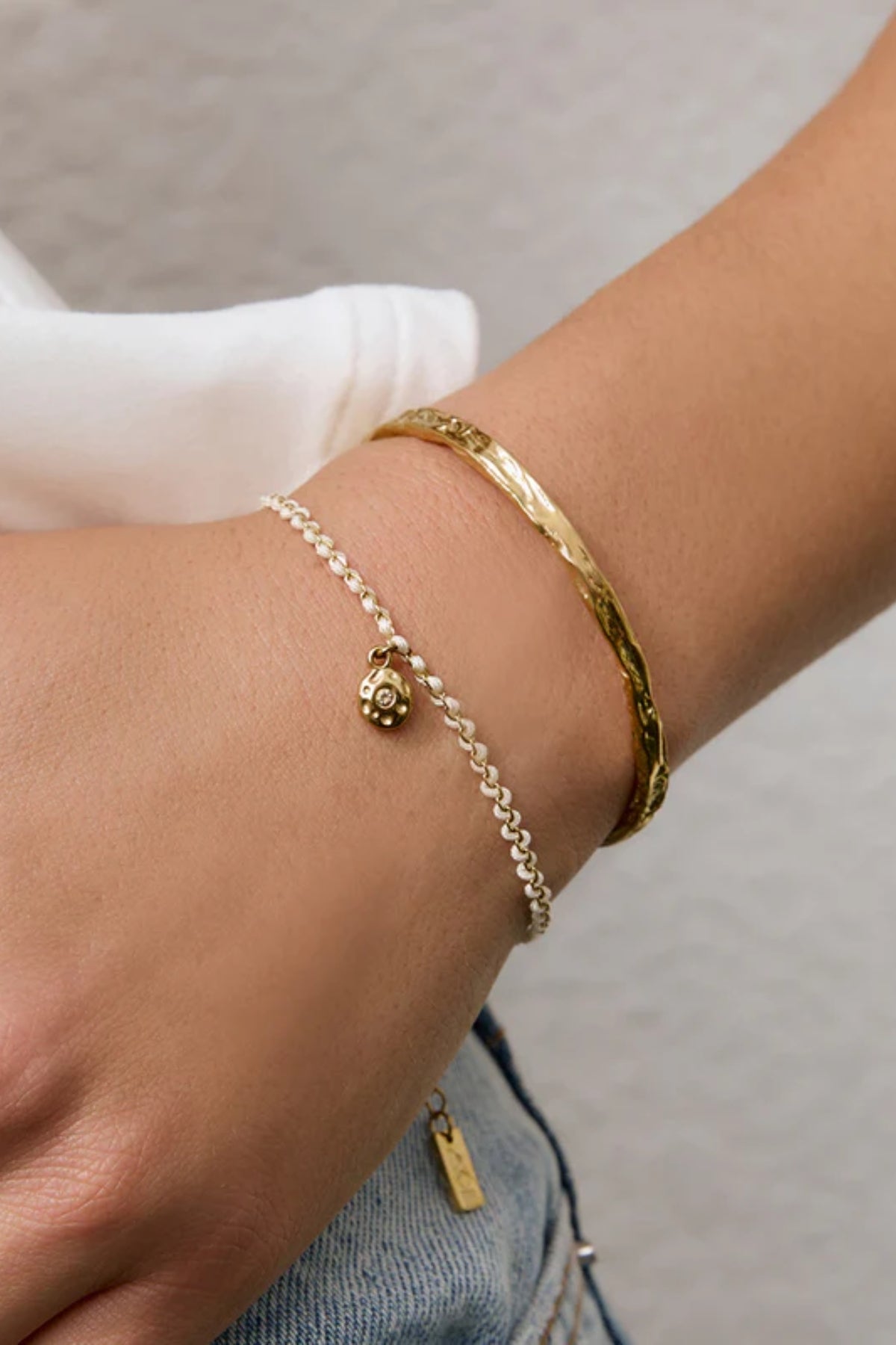 Lacey Bracelet Vanilla by Arms of Eve, minimalist rope bracelet with zircon charm in soft vanilla tones for a golden, playful summer touch.