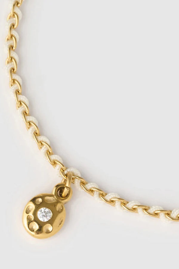 Lacey Bracelet Vanilla by Arms of Eve, minimalist rope bracelet with zircon charm in soft vanilla tones for a golden, playful summer touch.