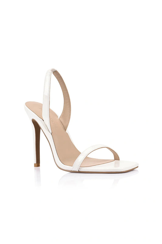 Lana Wilkinson Cassidy Sandal in white patent leather with slim stiletto heel and squared-off toe, perfect for party or summer wear.