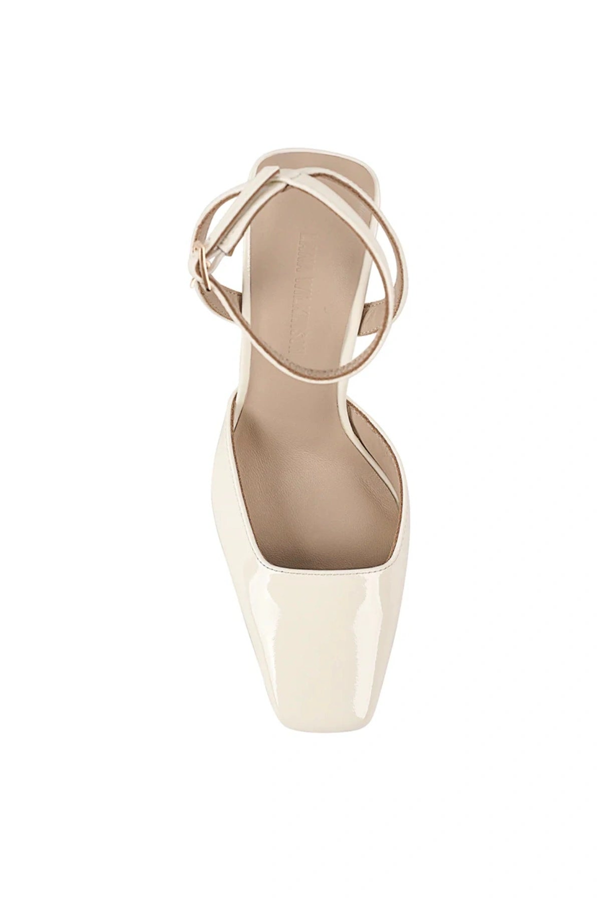 Lana Wilkinson Mona Wedge in glossy ivory patent leather with pointed toe, ankle strap, and sculptural wedge heel.