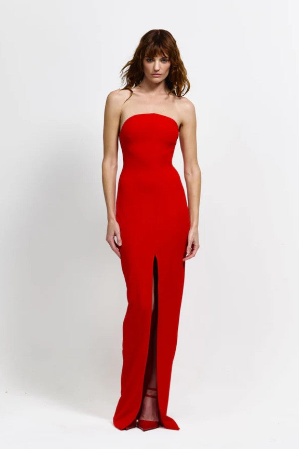 Lani Gown in Red by Effie Kats, a strapless floor-length gown with curved neckline, cinched waist, and bold front split for timeless evening elegance.