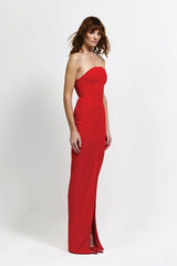 Lani Gown in Red by Effie Kats, a strapless floor-length gown with curved neckline, cinched waist, and bold front split for timeless evening elegance.