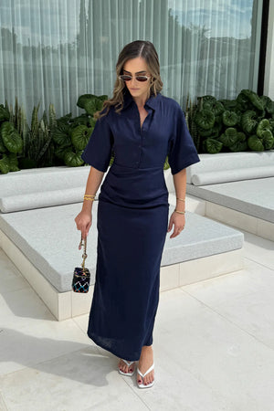 Lefka Midi Dress Navy by Sneaky Link – a linen midi with ruched waist and puff sleeves. Perfect for effortless event styling.