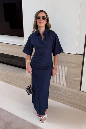 Lefka Midi Dress Navy by Sneaky Link – a linen midi with ruched waist and puff sleeves. Perfect for effortless event styling.