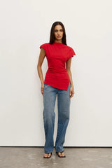 Liana Top Red by Bayse – draped cotton top with boat neckline and asymmetric hem for elevated everyday styling.