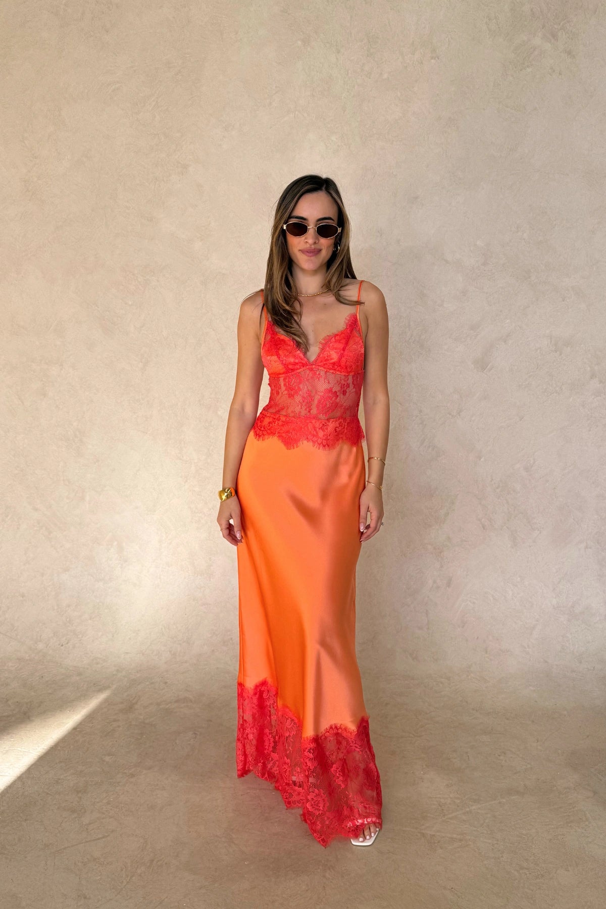 Lilah Maxi Dress in Orange by Sneaky Link, silk-lace maxi in vibrant tangerine with fluid drape and lace panels. Perfect for event dressing.

