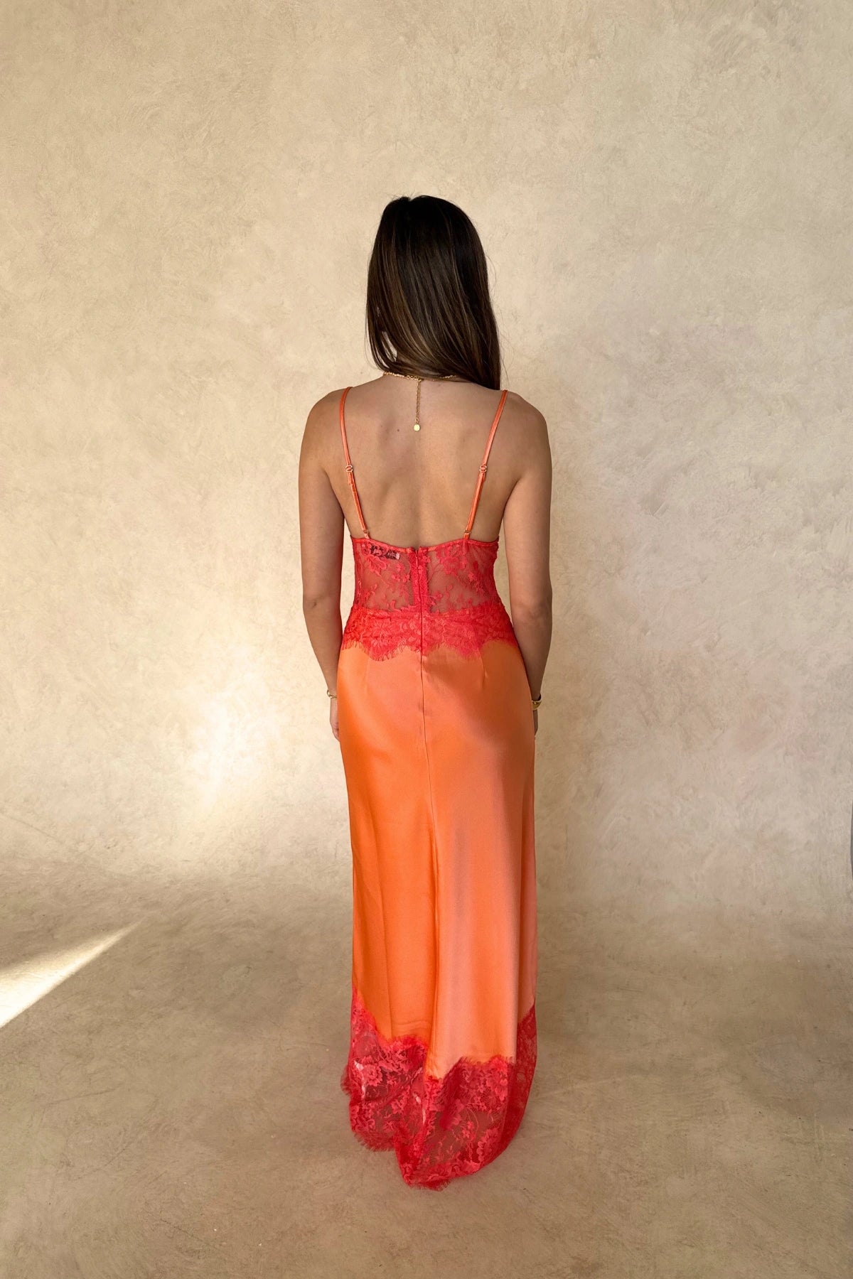 Lilah Maxi Dress in Orange by Sneaky Link, silk-lace maxi in vibrant tangerine with fluid drape and lace panels. Perfect for event dressing.
