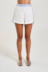 Linen Short by Summi Summi, linen shorts with embroidered trim and tailored fit. Perfect for summer styling or everyday wear.