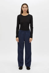 Locus Scuba Pant in Midnight by Camilla and Marc, a mid-rise scuba pant with side stripe detailing, pintuck legs, and zip hem finish.