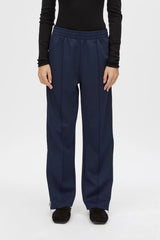 Locus Scuba Pant in Midnight by Camilla and Marc, a mid-rise scuba pant with side stripe detailing, pintuck legs, and zip hem finish.
