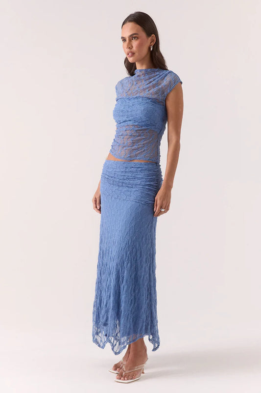 Lowri Skirt Slate Blue by Sovere, textured lace midi with asymmetric gathered waistband and handkerchief hem for soft, structured movement and effortless edge.
