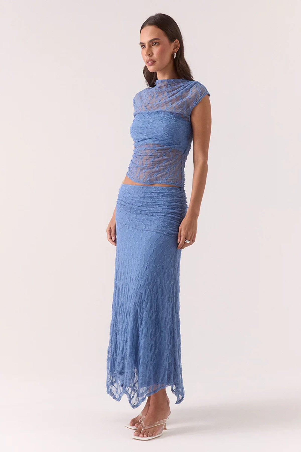 Lowri Skirt Slate Blue by Sovere, textured lace midi with asymmetric gathered waistband and handkerchief hem for soft, structured movement and effortless edge.