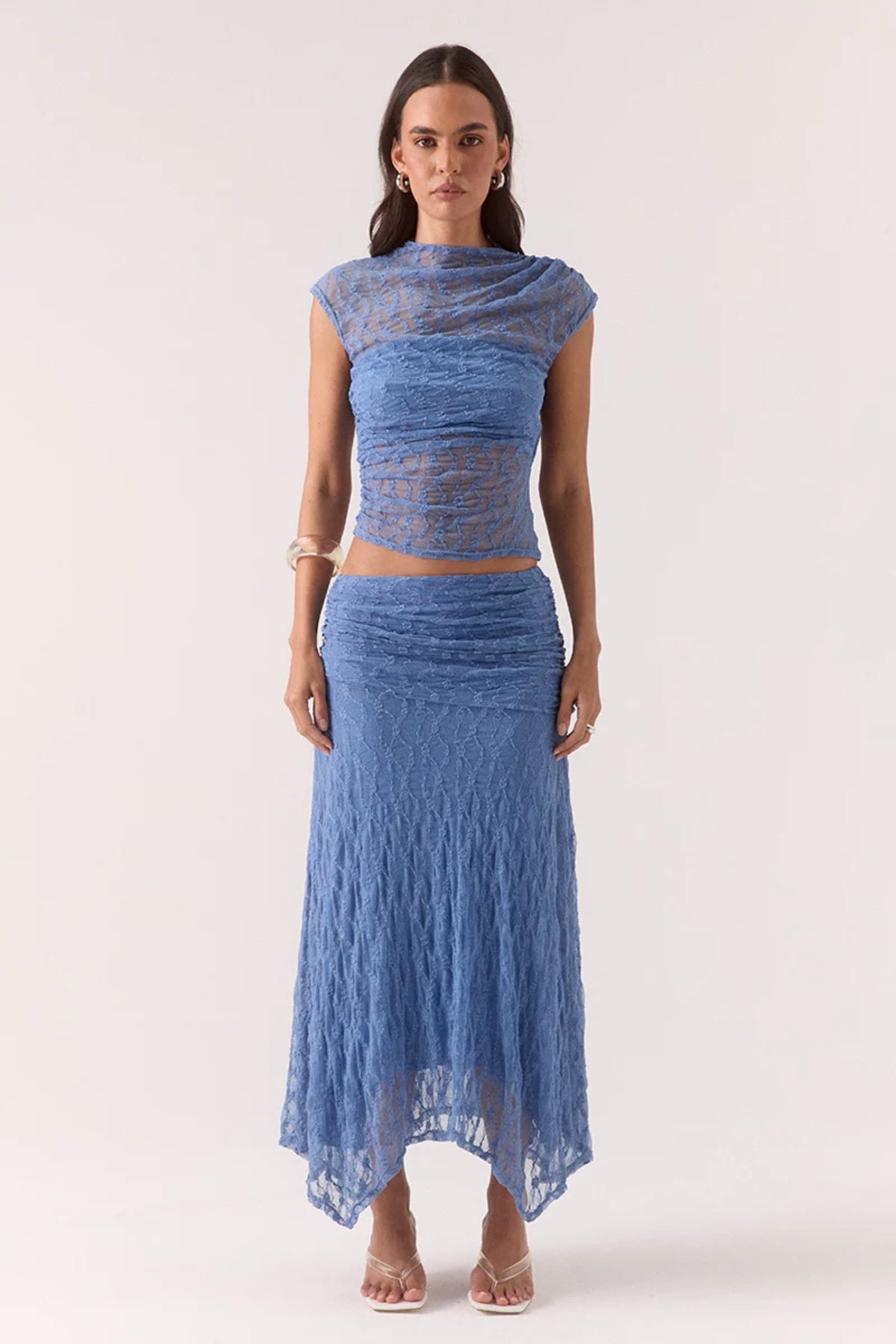 Lowri Skirt Slate Blue by Sovere, textured lace midi with asymmetric gathered waistband and handkerchief hem for soft, structured movement and effortless edge.