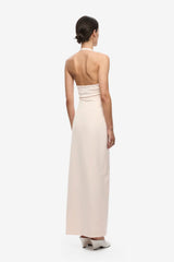 Luci Crepe Dress by Misha, a soft pink halter midi with plunging neckline, waist ruching and side split for elegant events.