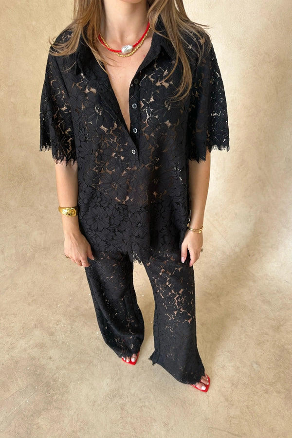 Lucy V-Neck Shirt in Black by Sneaky Link, crafted in sheer floral lace with a button front and relaxed fit. Ideal for matching sets.
