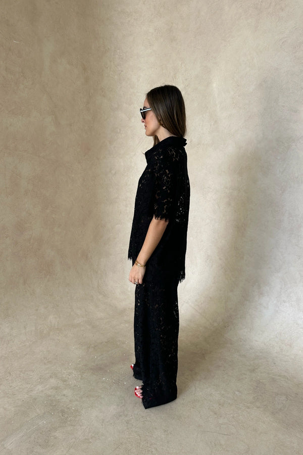 Lucy V-Neck Shirt in Black by Sneaky Link, crafted in sheer floral lace with a button front and relaxed fit. Ideal for matching sets.
