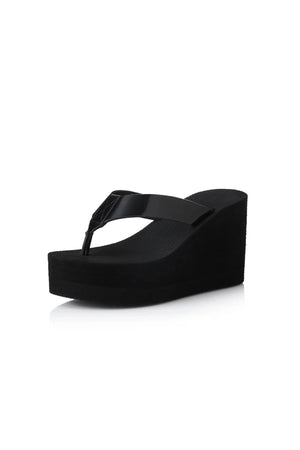 Lulu Sandal by Alias Mae, a bold black leather wedge with 9cm lift and clean silhouette. Perfect for elevated everyday or evening wear.
